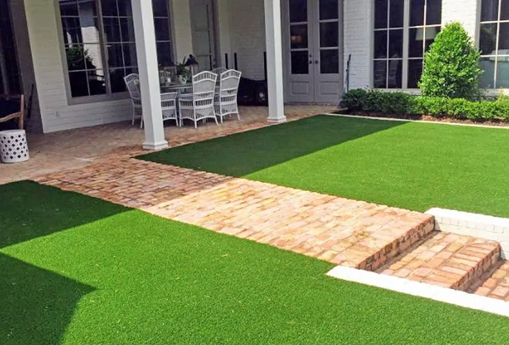 Courtyard turf panels on either side of a brick walk and steps